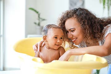 Mother giving her baby a bath