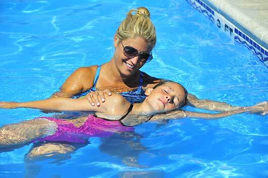 Swim instructor with swim student for water safety